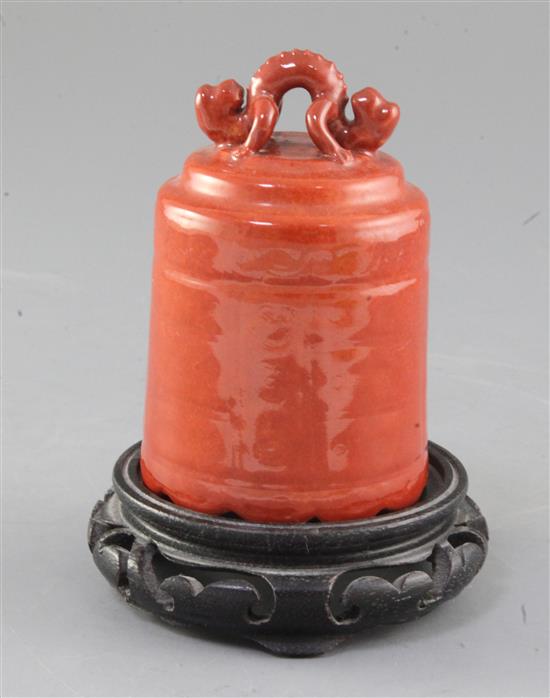 A Chinese coral red glazed model of a temple bell, Republic period, height 11cm, wood stand